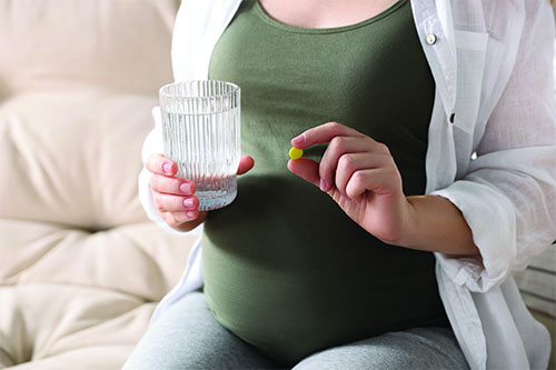 Pregnant woman taking pills