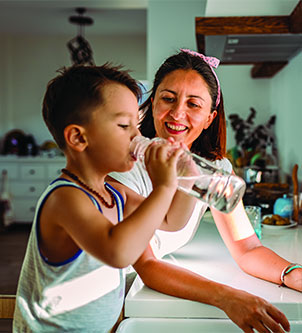 Mother helping to drink water