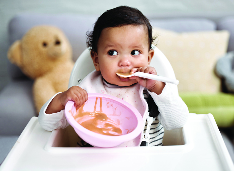 Baby eating with a spoon