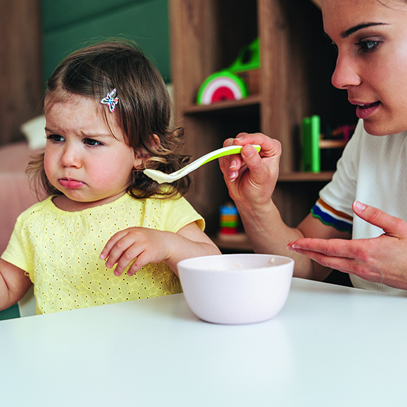 Baby being fed with spoon