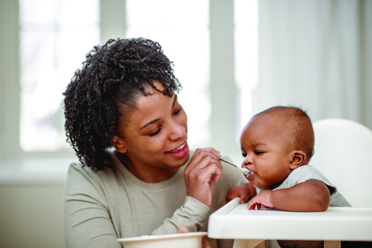 Young child pushing food away