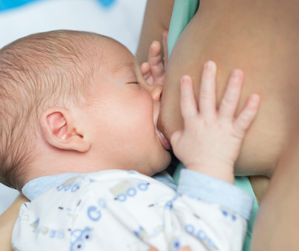Parent feeding a baby