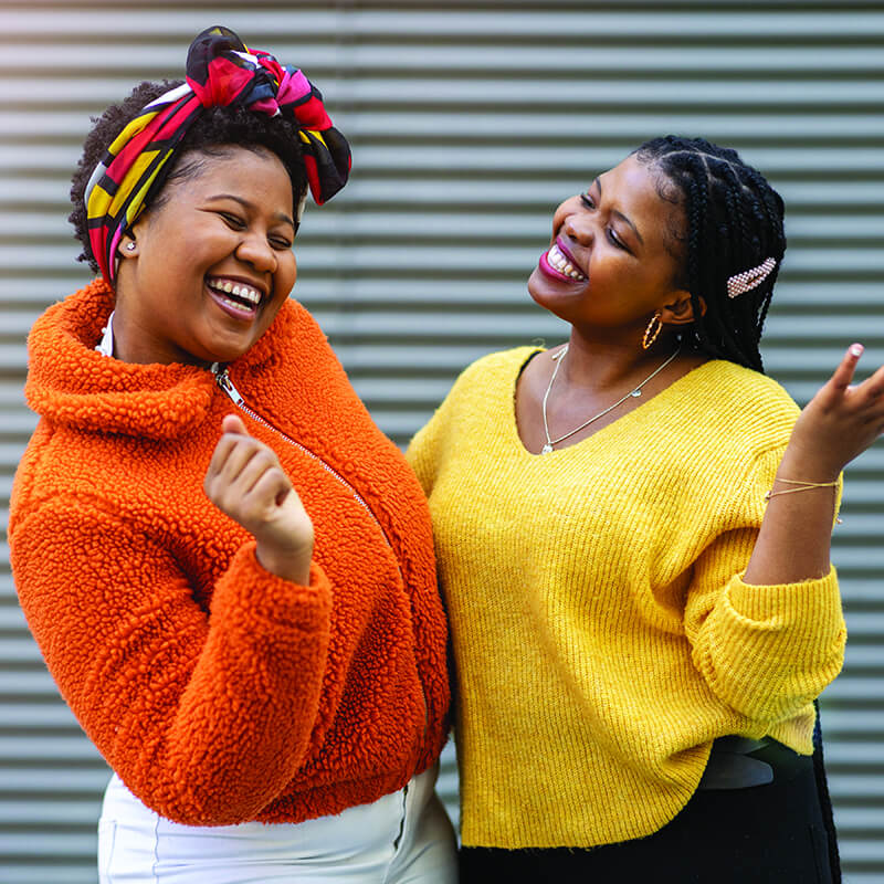 Two women smiling happily rotate